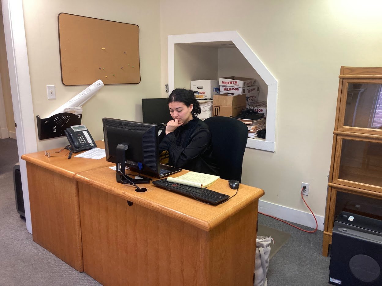 Raquel Camey_pic at desk doing research_law_MI3