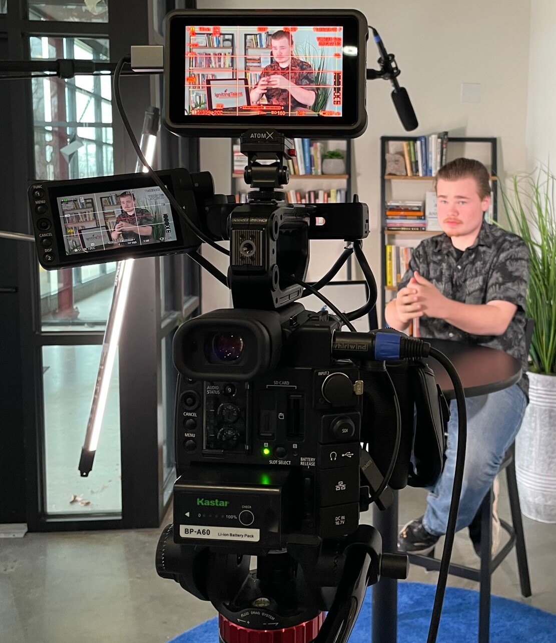 A student in front of a camera for a video shoot.