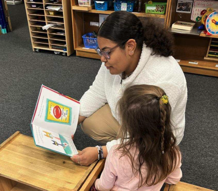 Student reading to a child at the Branford Early Learning Center